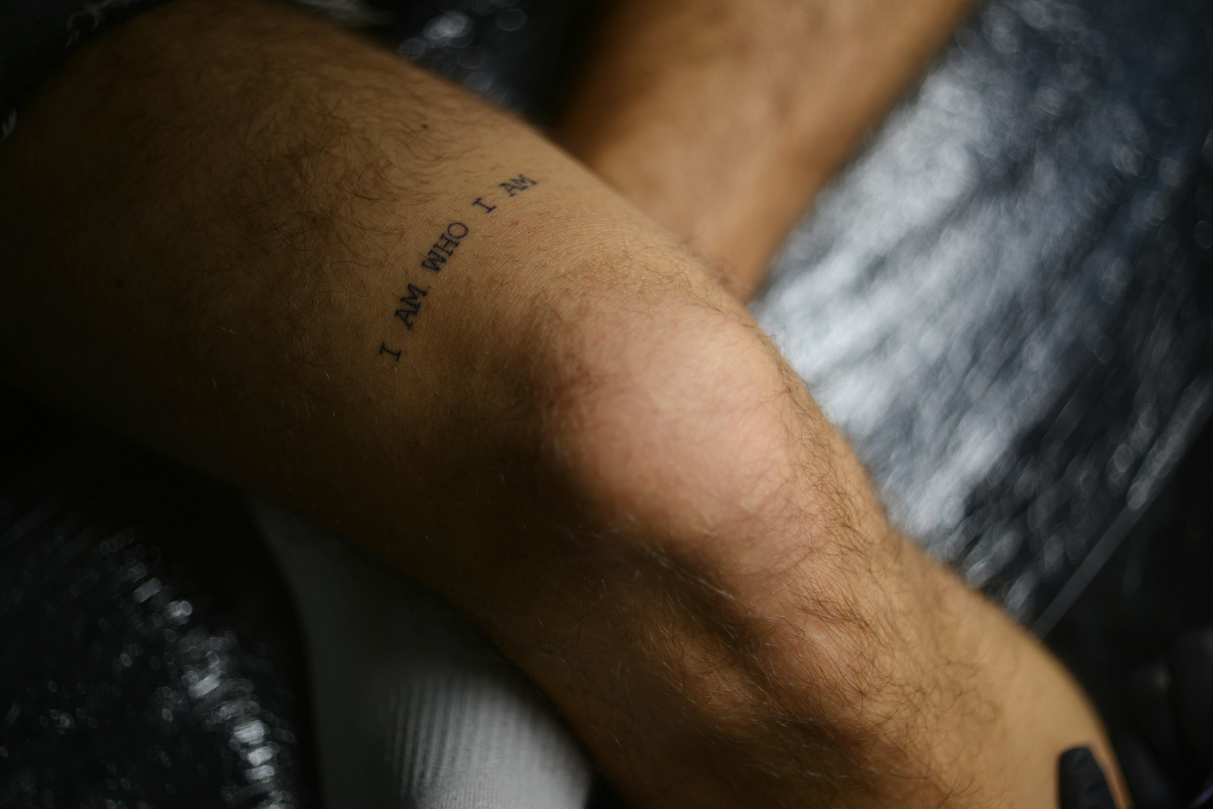 Small serif lettering tattoo photographed in the studio