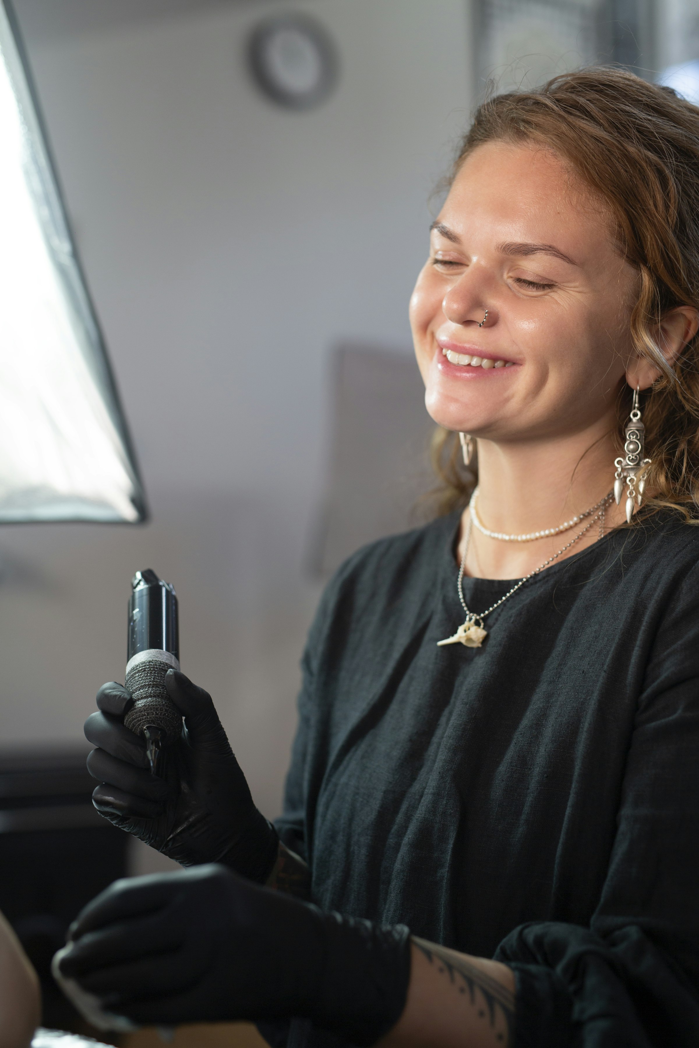 Tattoo artist holding a machine in the studio
